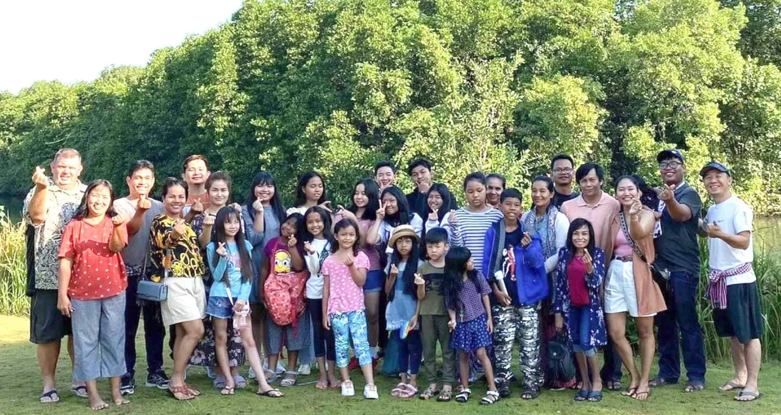 Naleng Real with the Words of Life staff and their families, gathered outdoors at the 2022 retreat