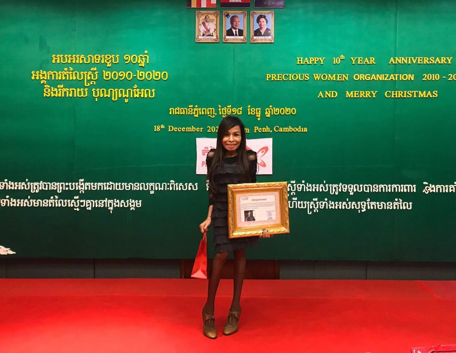Naleng Real receiving an achievement award as chairperson of Precious Women Organization
