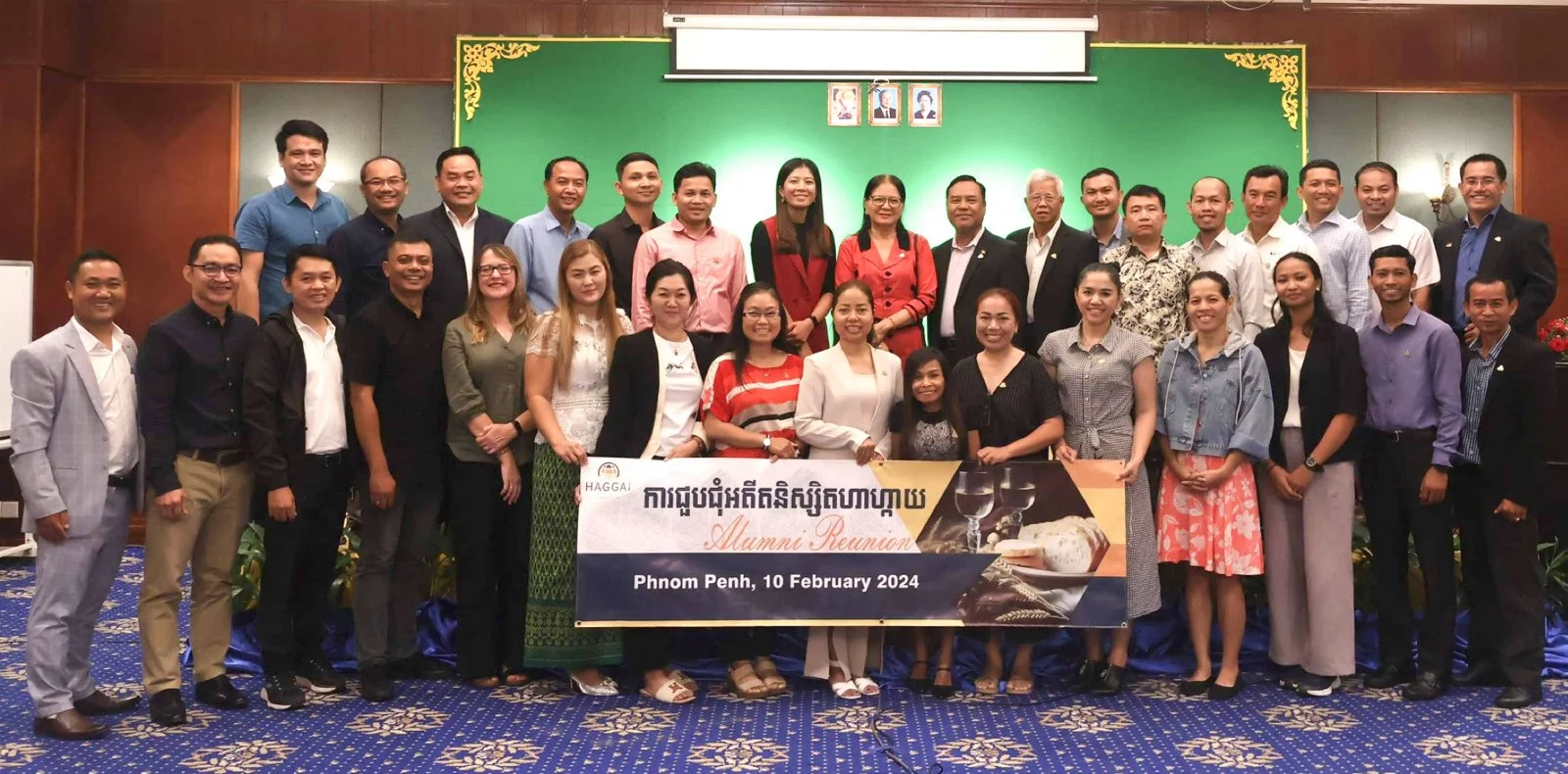 A large group at the Haggai Alumni Reunion in Phnom Penh holding a banner dated 10 February 2024