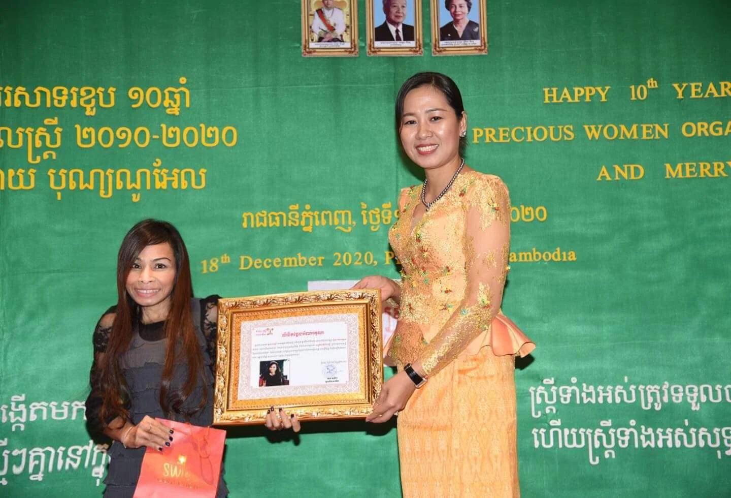 Naleng Real receiving a framed certificate at the Precious Women Organization tenth anniversary in December 2020