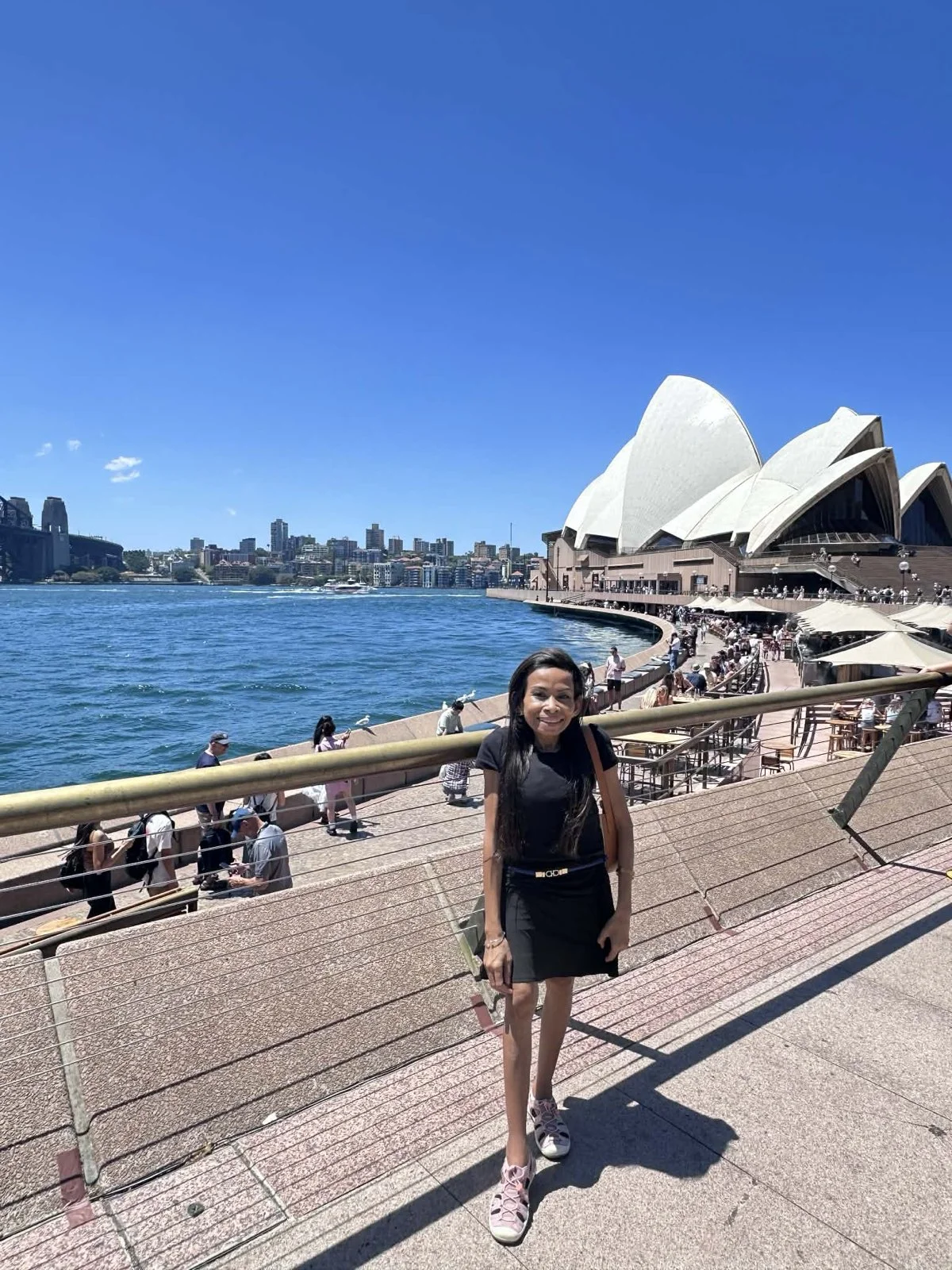Naleng Real standing on the waterfront in front of the Sydney Opera House